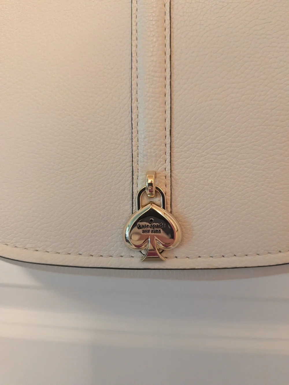 kate spade Cream Pebbled Leather Saddle Crossbody with Gold Heart Charm